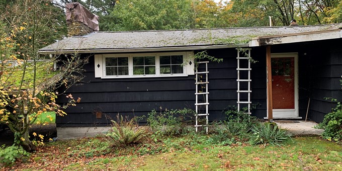 Single-story black house with white trim on Parker Property in Sammamish that will be demolished.